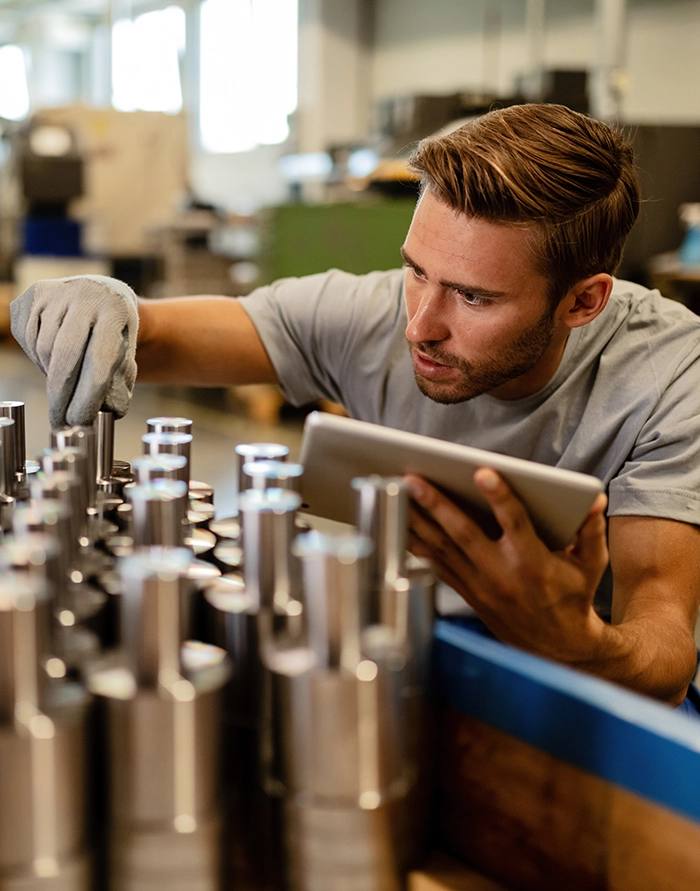 Industrial engineer reviewing project plans at a manufacturing facility